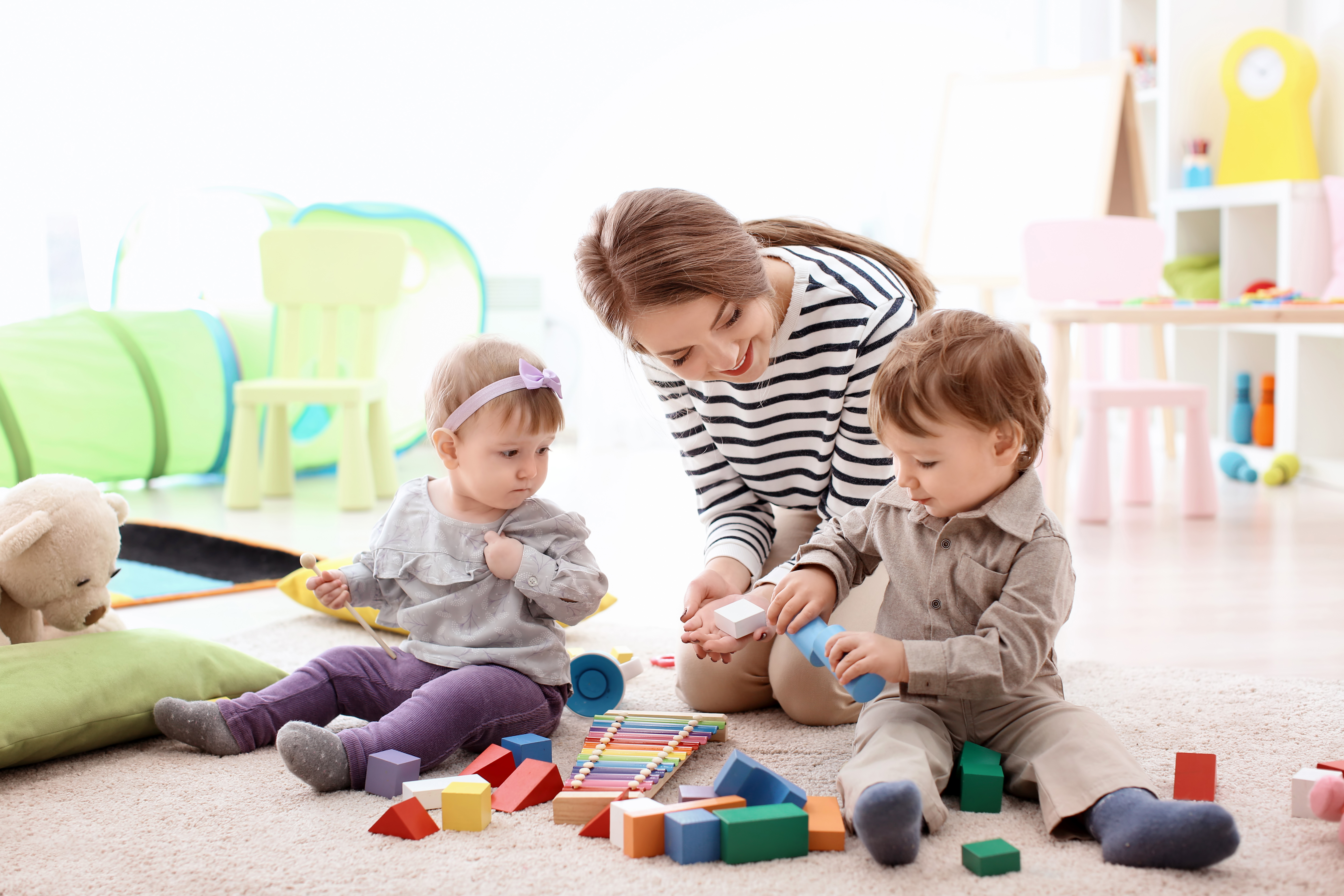 Nanny and two children playing